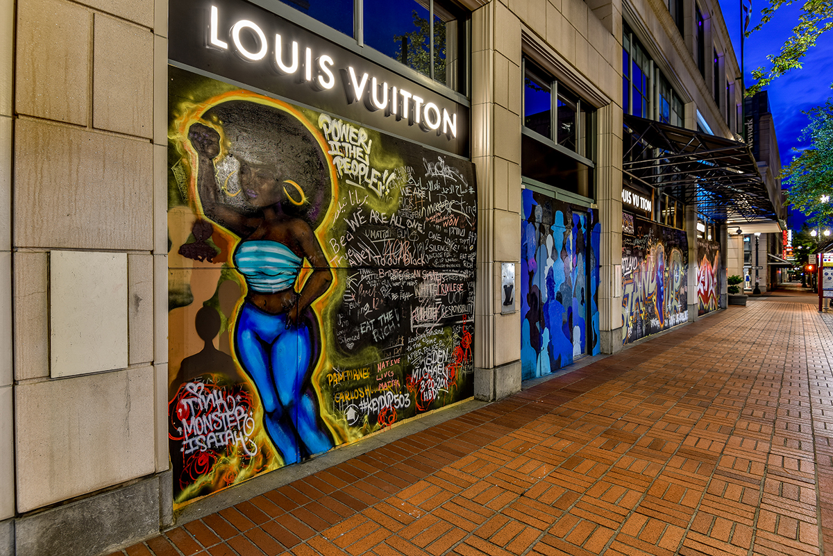 A mural outside Lous Vuitton in Portland features messages such as "Power II the People!!"