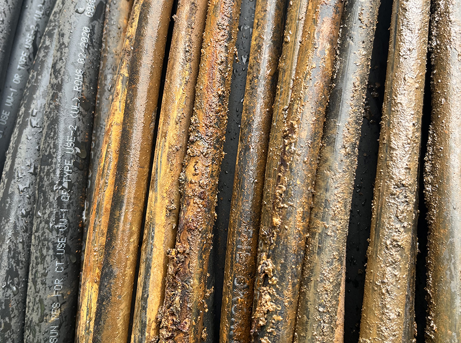 A close up image of a grouping of rusting cables.