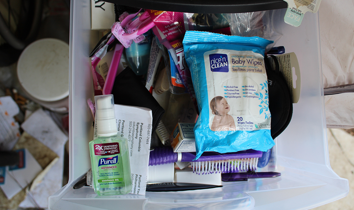 A drawer filled with hand sanitizer, baby wipes and other hygiene items
