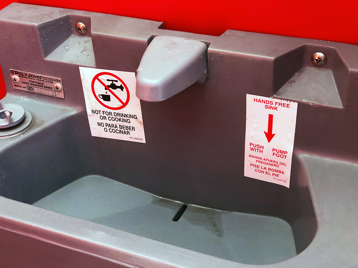 Hand-washing station inside a portable toilet in Portland