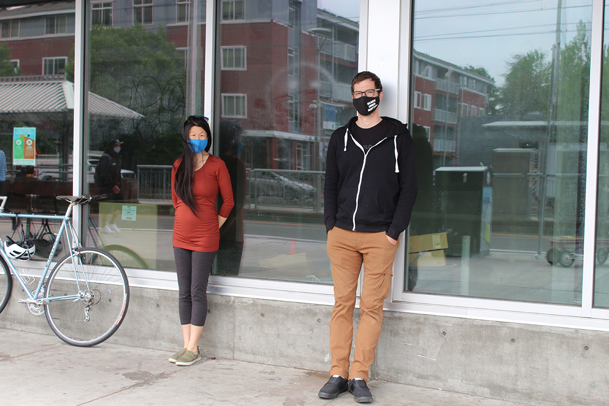 Christina Horrigan and Jesse Prichard stand outside the Blackburn Center, distanced from each other and wearing masks
