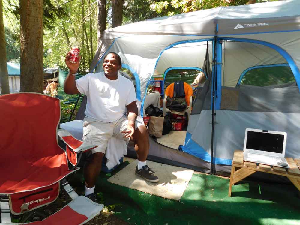 Eric, a resident of Tent City 3 in Seattle, Wash., sits outside the tent where he's lived for the past year.