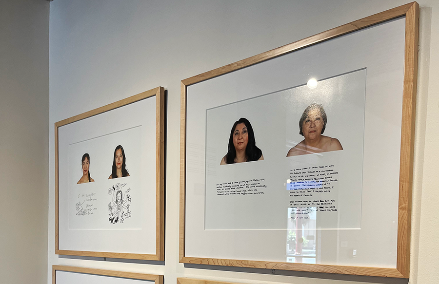 Framed photos hang on a white wall in a gallery. The photos show side by side portraits of the same person 15 years apart with a message in their own handwriting below each image.