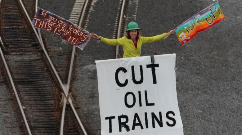 Abby Brockway of Seattle stands on top of an 18-foot tripod to protest poor train safety.
