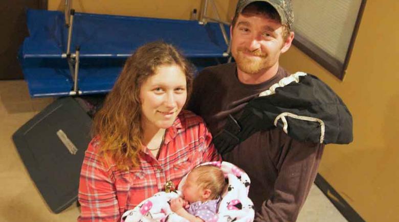 Aubrie (left), T.J., and their daughter Abbie are one of more than 30 families — 126 people in all — who slept at the homeless family shelter on Tuesday, May 12, 2015.