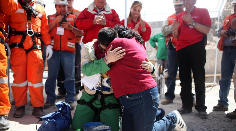 Trapped miner Esteban Rojas hugs his wife as he prays after reaching the surface to become the 18th person to be rescued from the San Jose mine in Copiapo on Oct. 13, 2010.
