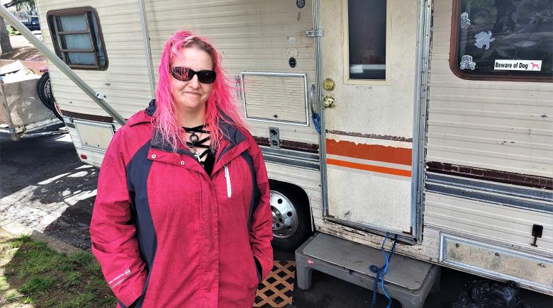 Photo shows Hope Dryden standing in front of her RV in McMinnville