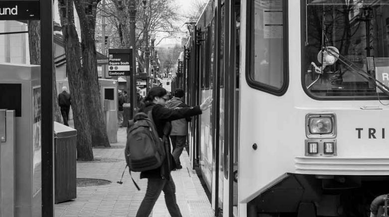Street Roots photo: A rider boards TriMet's Red Line MAX train in Portland, Oregon