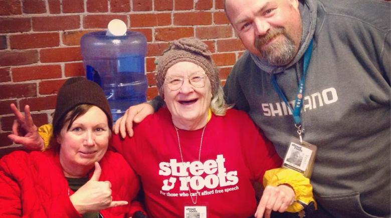 Vendors Andi Howard, Paulette Bade and Allen Bennet smile for the camera at the Street Roots office.