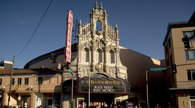 A street view of the Hollywood Theatre. The marquee says, "Black Friday, Basic Instinct."