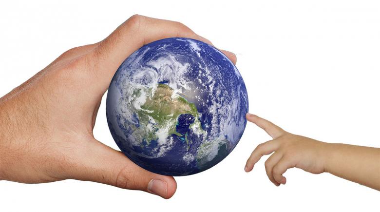Photo illustration of an adult handing the Earth to a child