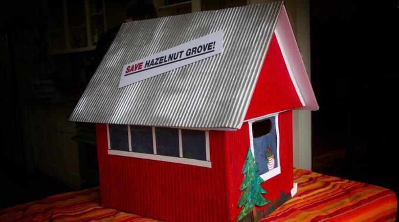 A red tiny house that contained the petition to save Hazelnut Grove