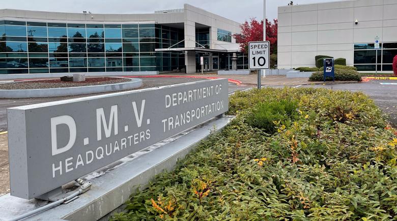 A photo of the sign and building of the Oregon DMV headquarters.