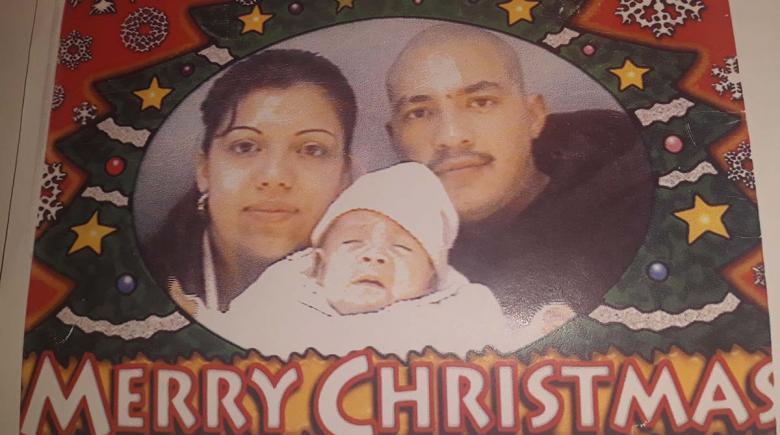 Photo of Enrique Bautista, his wife and daughter in December 2001 on a photo that says "merry christmas."