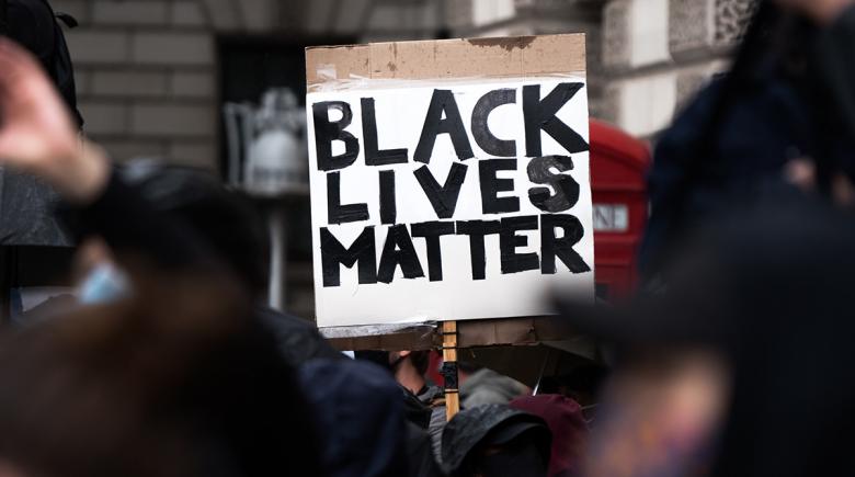 Black Lives Matter protest sign in a crowd