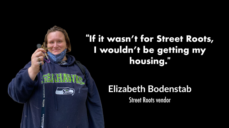 A cutout of Street Roots vendor Elizabeth Bodenstab is next to a quote by her in white text. She is smiling and holding up keys on a lanyard. The quote says, "If it wasn’t for Street Roots, I wouldn’t be getting my housing."