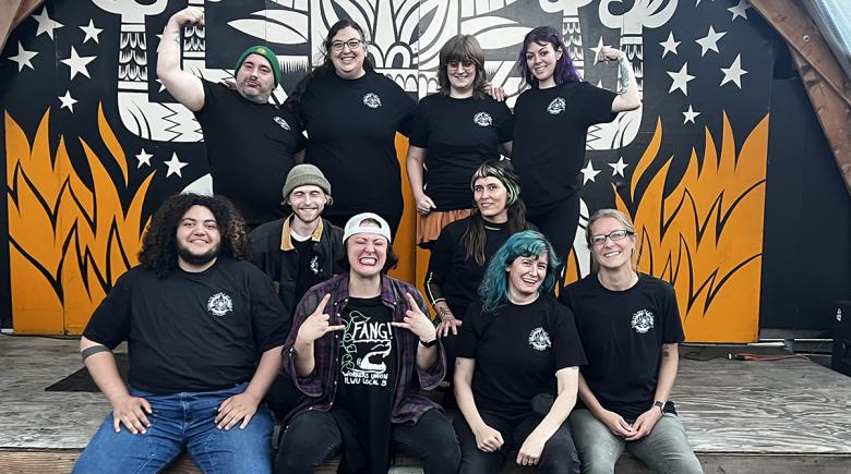 A group of photo of 10 people smiling and wearing black t shirts.