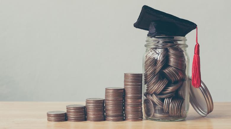 Stacks of coins with a graduation cap