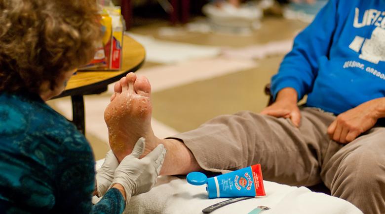 A health care provider helps someone with foot relief