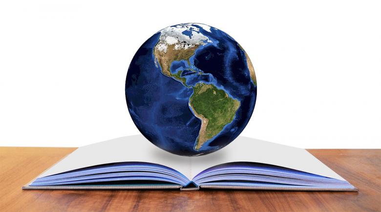Photo illustration of a globe and a book