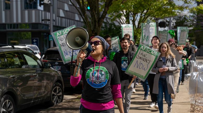 photo shows AFSCME worker rallying to support a fair contract for Postdoctoral workers at OHSU on April 16.
