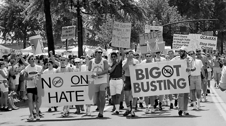A crowd of people in a black and white photograph showing a march against Ballot Measure 9.