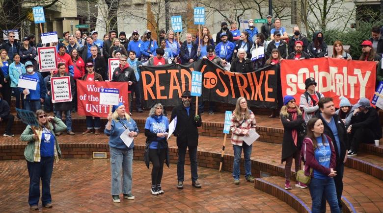 Portland Community College Federation of Faculty and Academic Professionals hold signs and banners saying "ready to strike" and "solidarity"