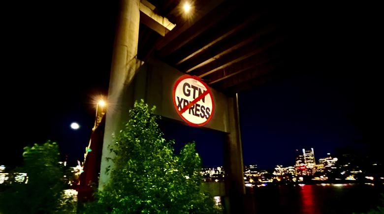An image projected underneath a bridge. The image shows "GTN Xpress" crossed out with a red line.