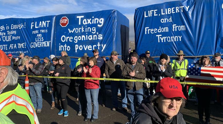 Signs on large trucks protest taxes and government control