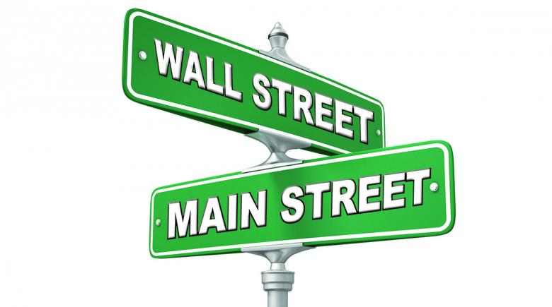 Street signs showing intersection of Wall Street and Main Street