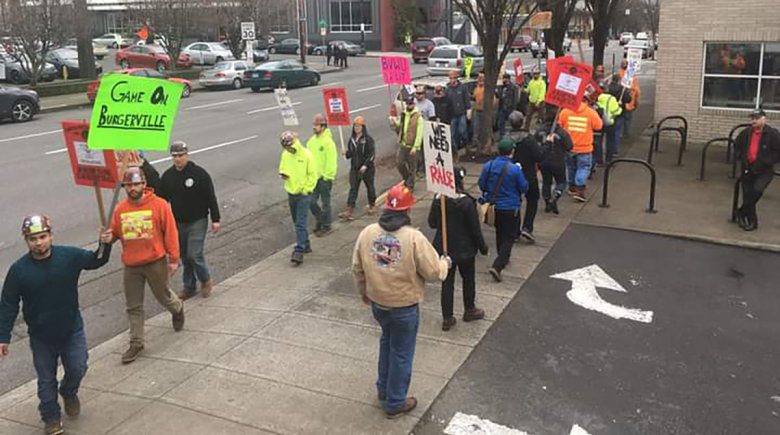 Picketing workers outside of a Burgerville location in Portland near the Oregon Convention Center.
