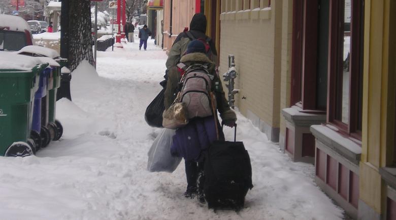 People carry their possessions through the snow in Old Town Portland