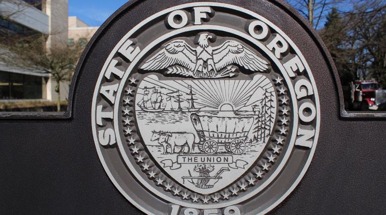 A photo of a physical monument of the Oregon state seal