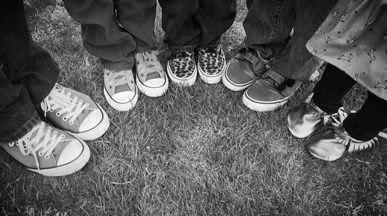 Kids gathered in a half-circle for a portrait of the group's feet