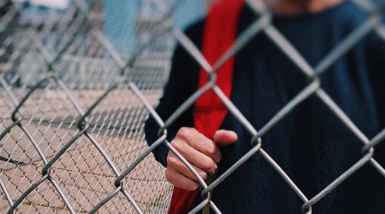 Boy holding a backpack