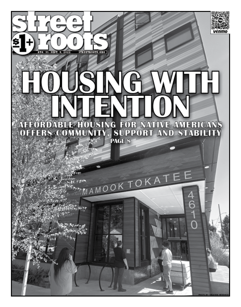 Cover of Street Roots August 31, 2022 cover. In the background is a photo of an apartment building with words on it that read, "Mamook Tokatee." Text in the foreground says, "HOUSING WITH INTENTION. AFFORDABLE HOUSING FOR NATIVE AMERICANS OFFERS COMMUNITY